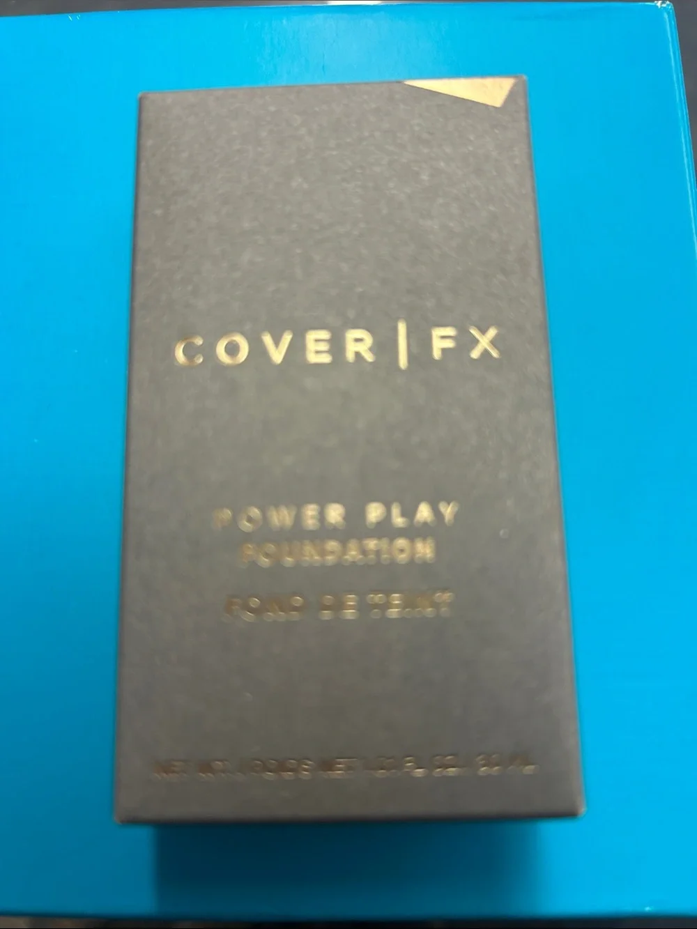 COVER FX Power Play Foundation — Matte Black with Gold Accents Shade M4